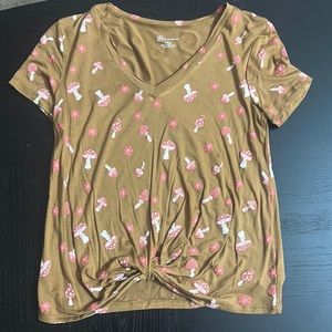 A t-shirt in size small with a mushroom and flower print
